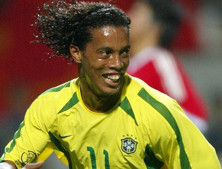 Ronaldinho celebrating a skillful dribble and smile